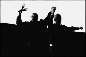 Oasis - Liam and Noel Gallagher on stage in 2025. Black and white image.