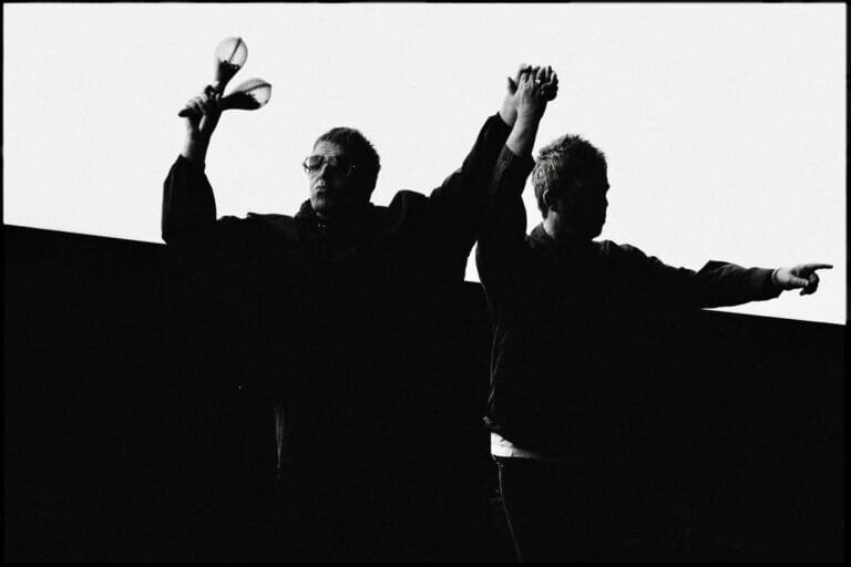Oasis - Liam and Noel Gallagher on stage in 2025. Black and white image.