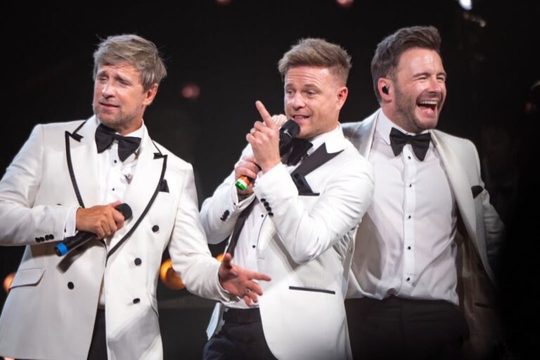 Westlife on stage in white suits