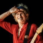 Keith Richards in a red shirt on stage