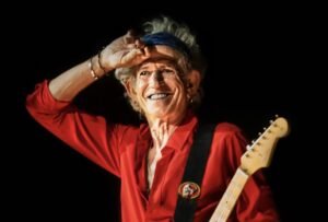 Keith Richards in a red shirt on stage