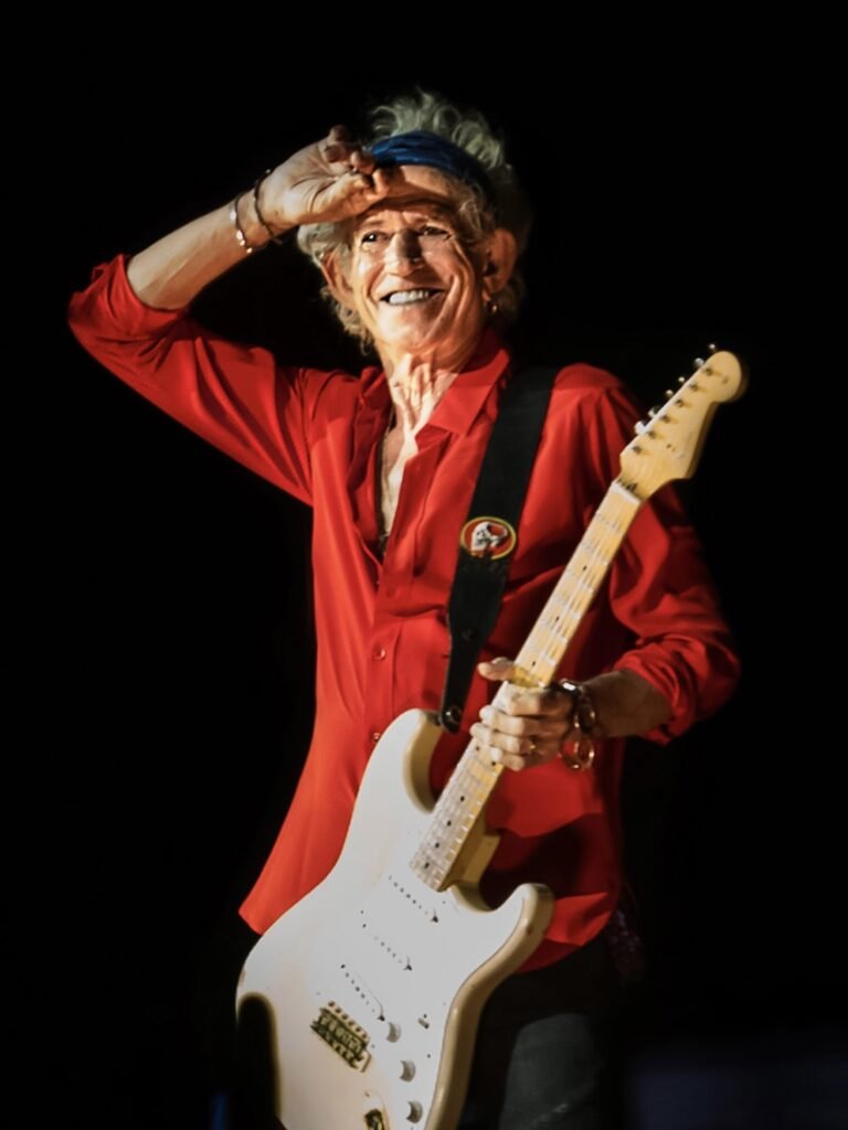 Keith Richards in a red shirt on stage