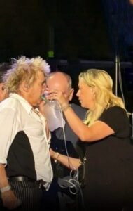 Rod Stewart with oxygen tank on stage