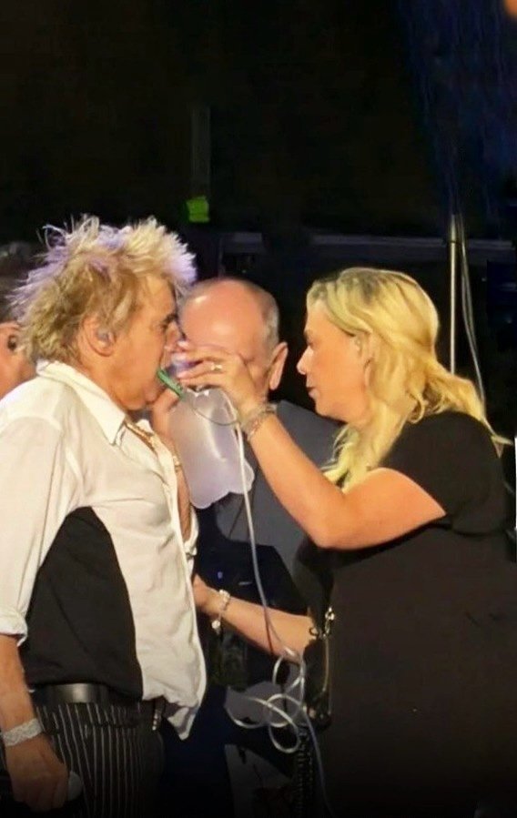 Rod Stewart with oxygen tank on stage
