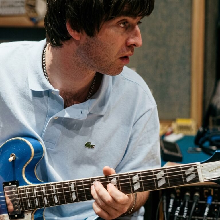 Noel Gallagher with blue Epiphone guitar